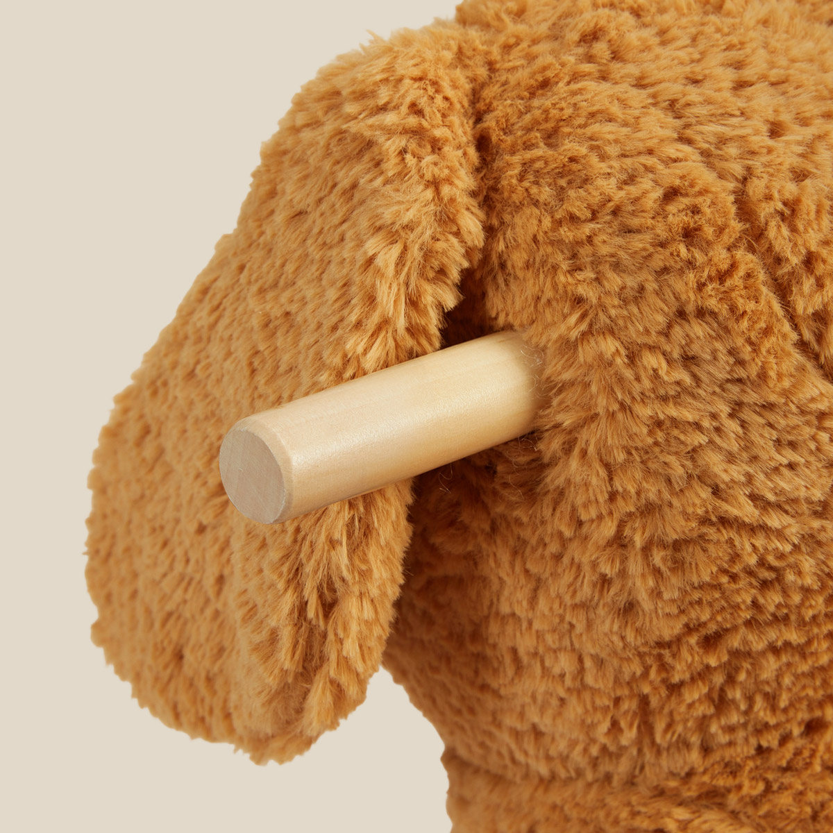 Close-up of Labrador puppy rocker wooden handle and plush ear detail