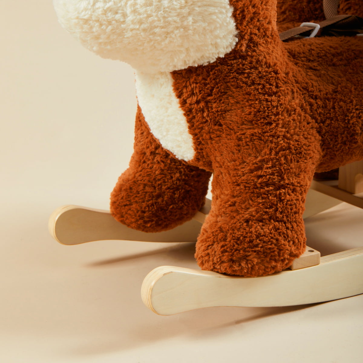 Close-up of fox plush rocker foot and wooden rocking base