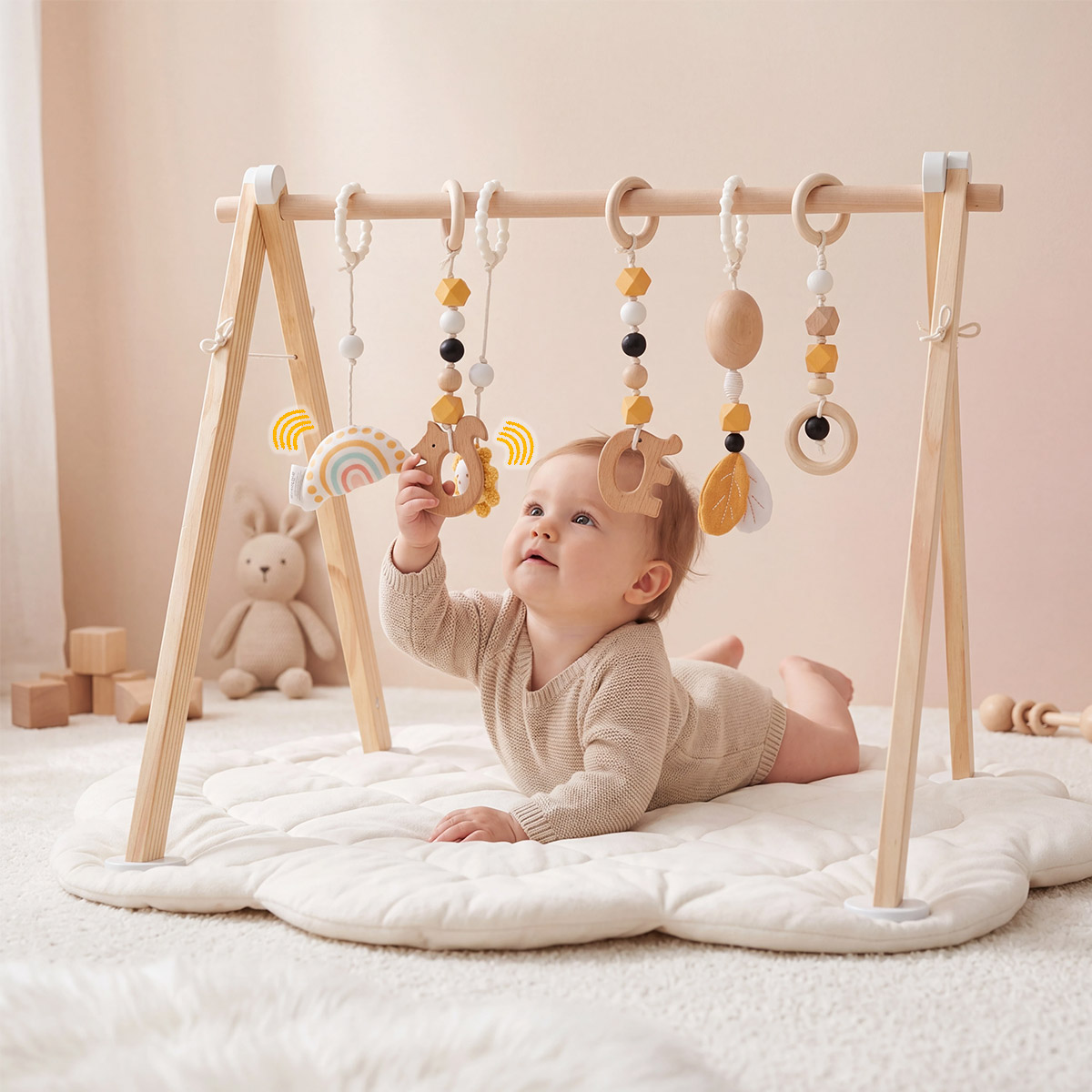 Baby reaching for toys on Montessori wooden play gym