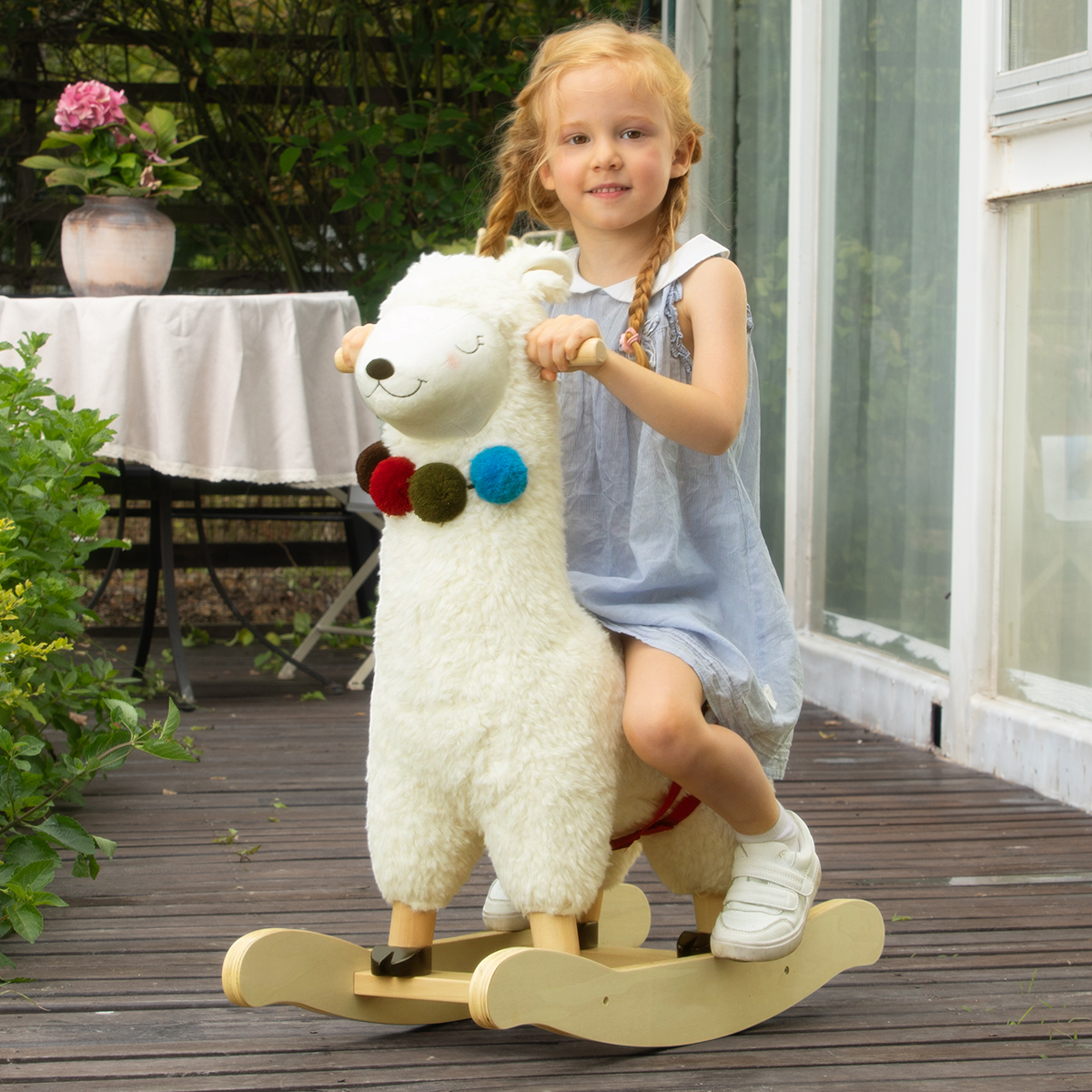 Child riding soft llama plush rocker with wooden handles