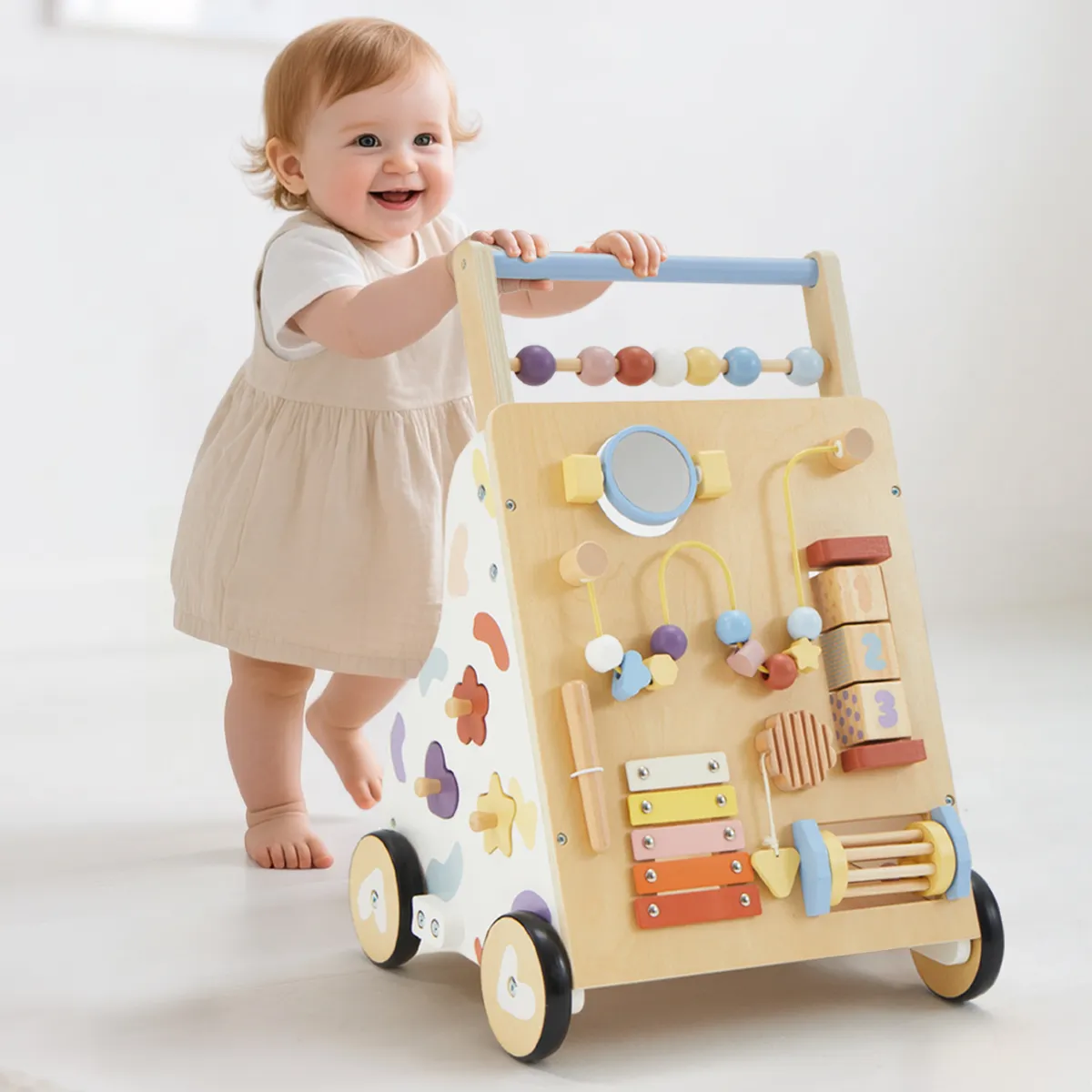 Toddler standing and learning to walk with wooden activity push walker
