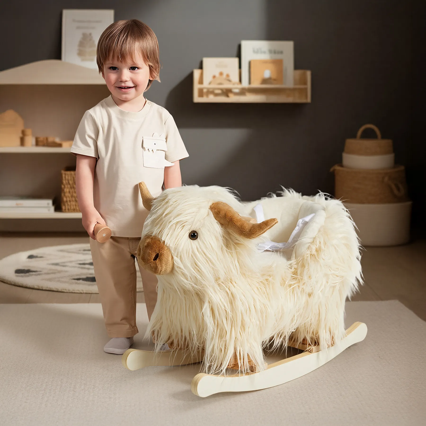 A boy playing with a White Highland Cow plush rocker