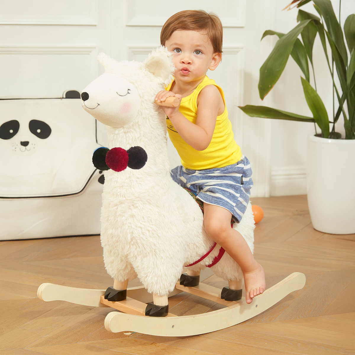 Toddler riding soft llama plush rocker with wooden handles