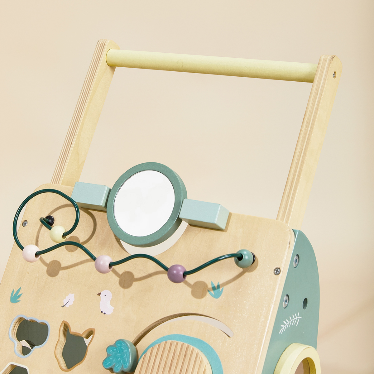 Close-up of wooden baby walker with bead maze, mirror and handle