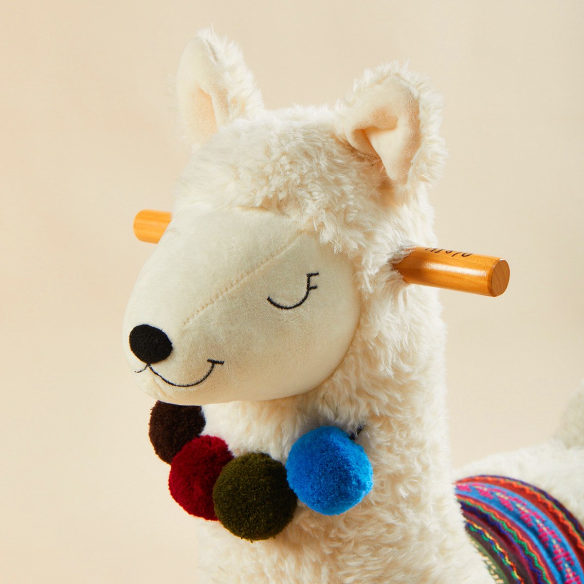Close-up of labebe llama plush rocker with soft fabric and wooden handles