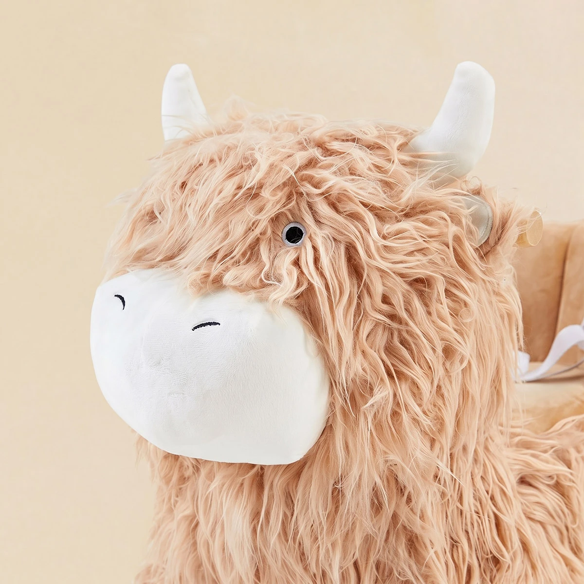 Close-up of soft plush yak rocking horse head and horns