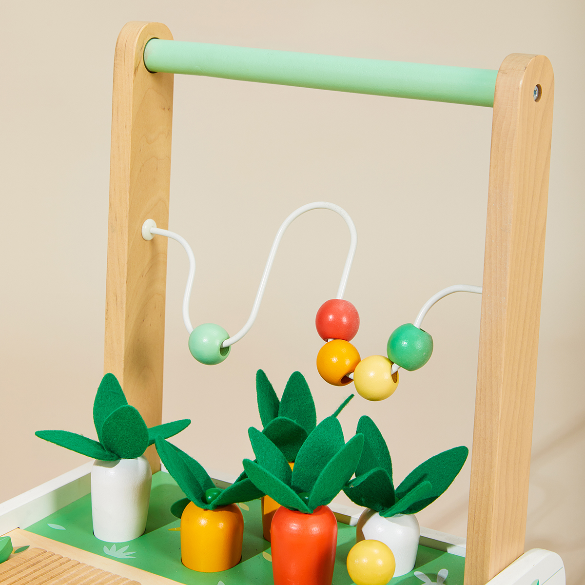 Close-up of farm activity walker with bead maze and garden-themed play details