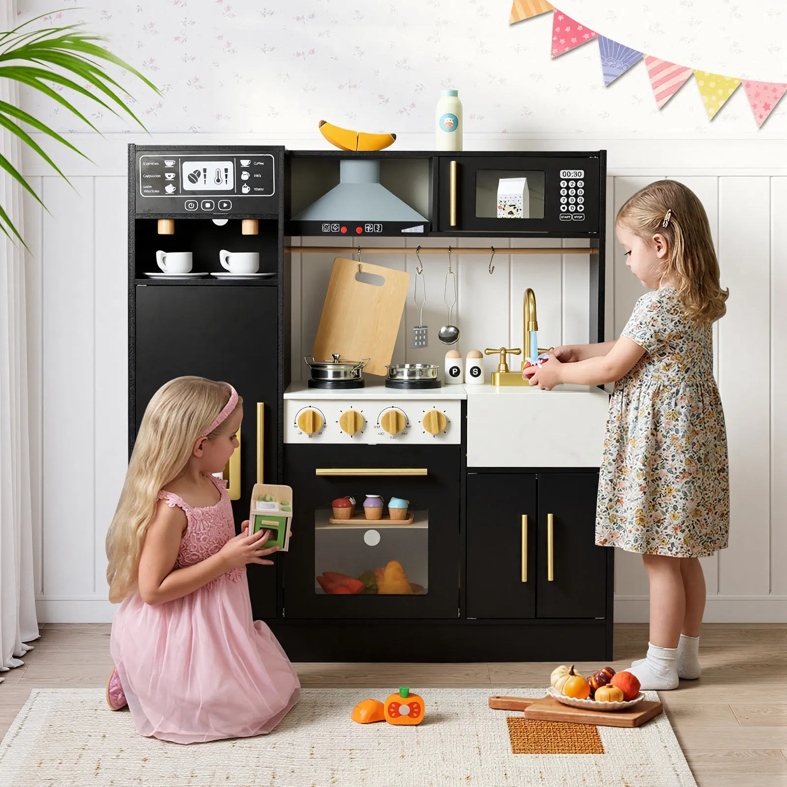 Two young girls playing pretend cooking at black modern wooden play kitchen