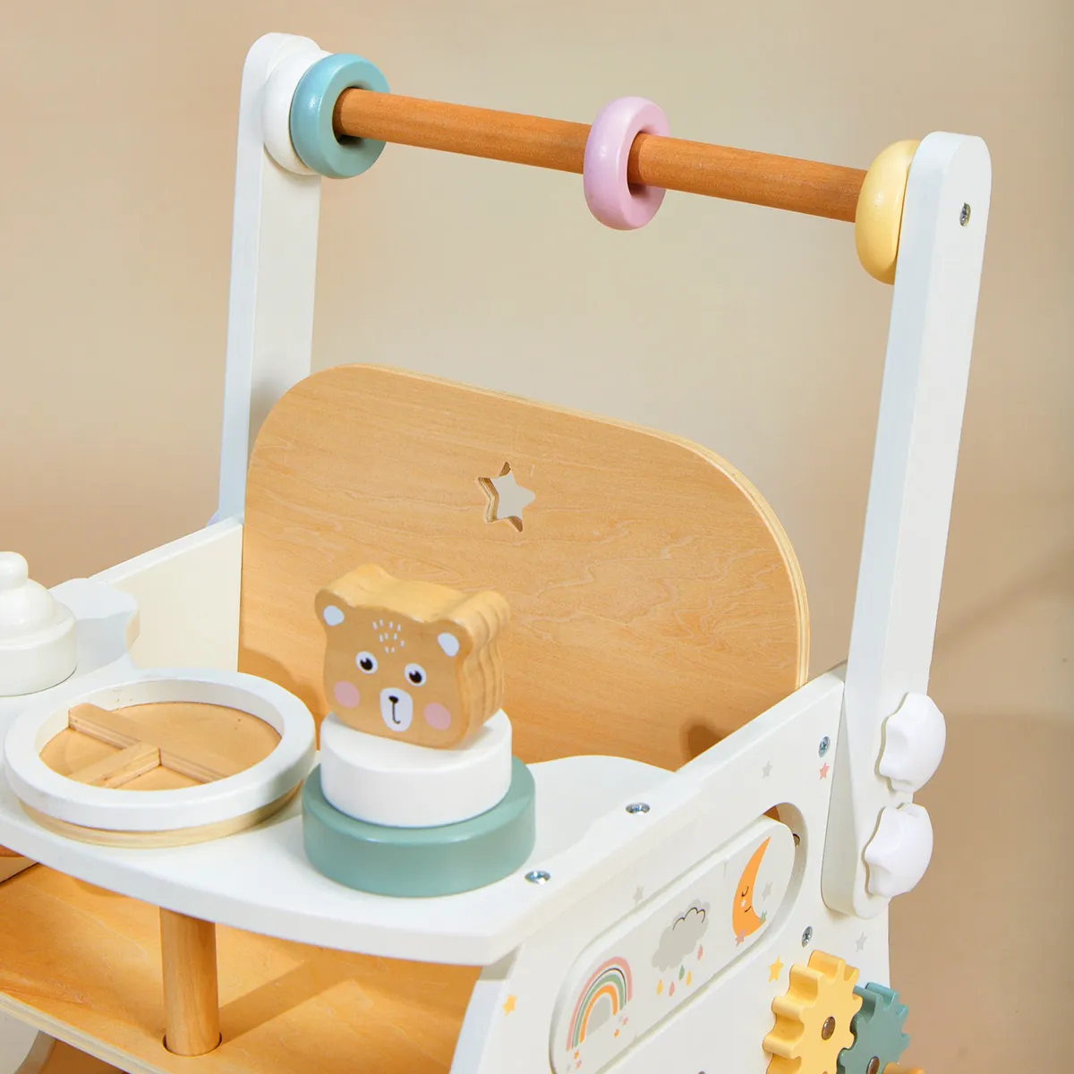 Close-up view of doll seat and play tray with wooden feeding accessories